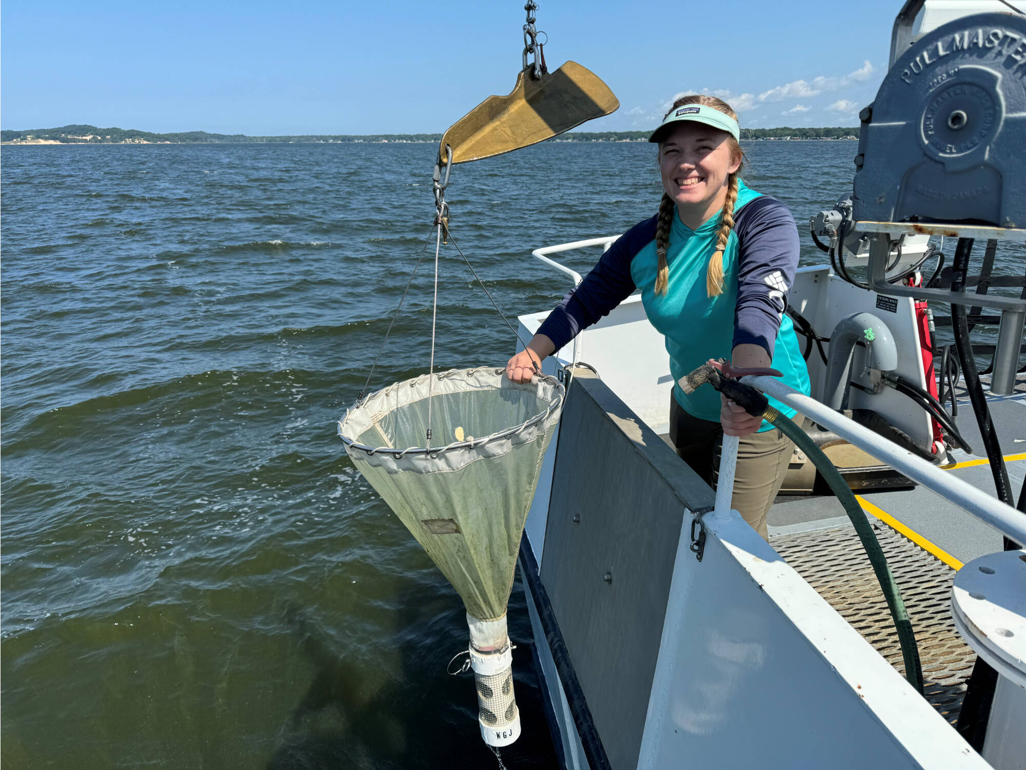 Technician with plankton tow net on the W.G. Jackson.